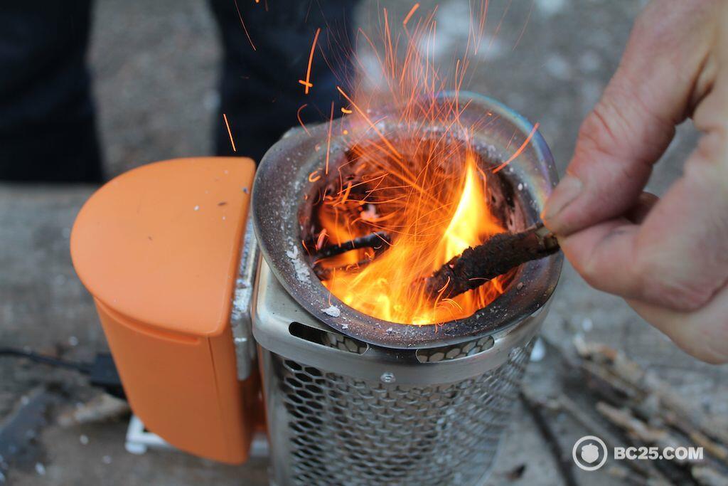 feeding biolite stove with small wood sticks