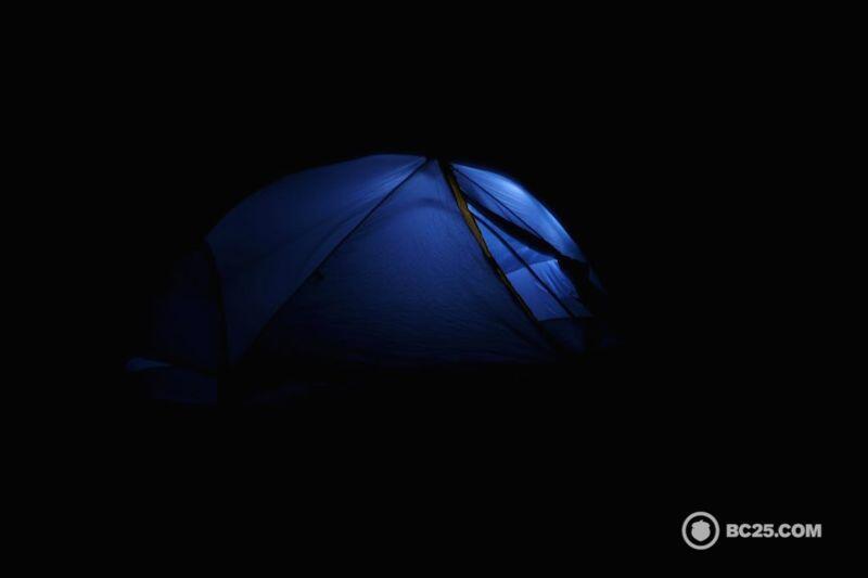 tent at night illuminated by headlamp